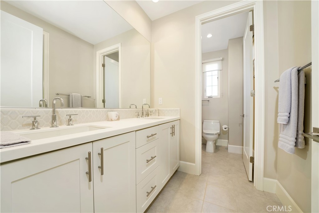 208 Villa Ridge Irvine, CA 92602 - Photo 32 of 46 a spacious bathroom with a double vanity sink a mirror and a toilet
