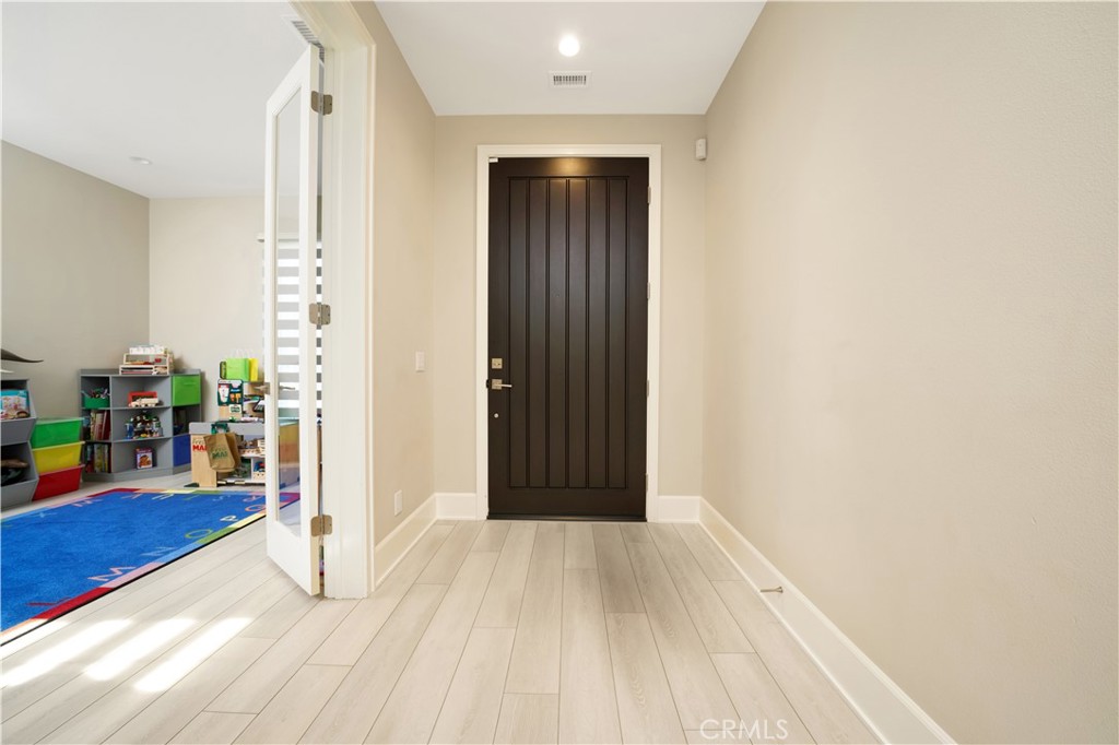 208 Villa Ridge Irvine, CA 92602 - Photo 33 of 46 a view of a hallway with wooden floor and a living room