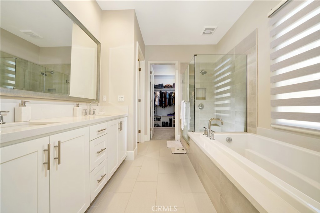 208 Villa Ridge Irvine, CA 92602 - Photo 34 of 46 a spacious en suite bathroom with a double vanity sink a mirror and a bathtub