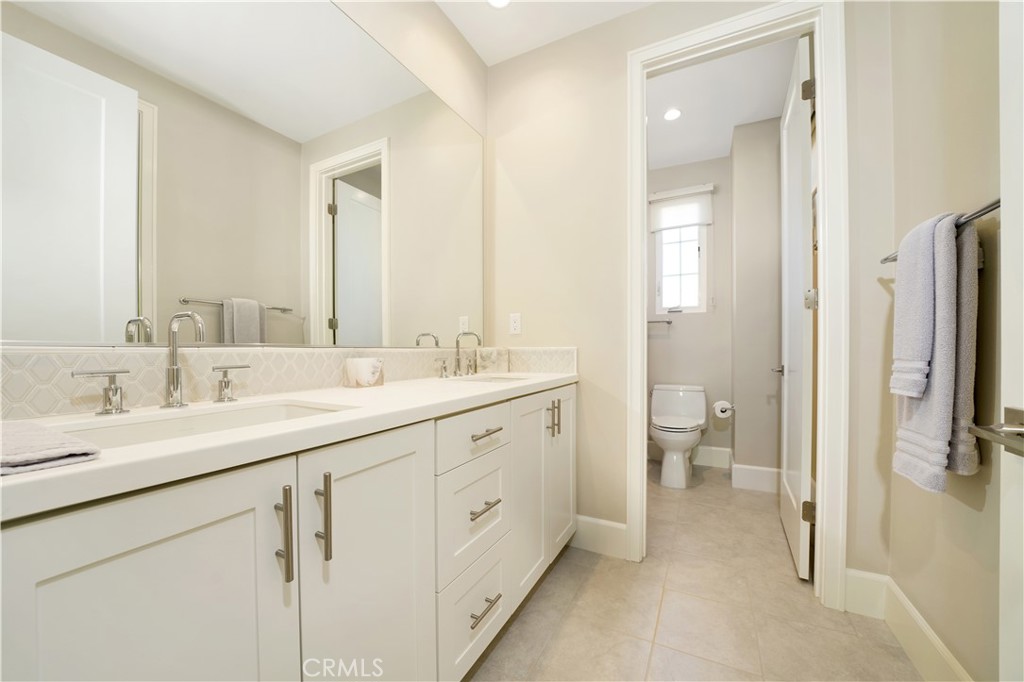 208 Villa Ridge Irvine, CA 92602 - Photo 7 of 46 a spacious bathroom with a double vanity sink a mirror and a toilet