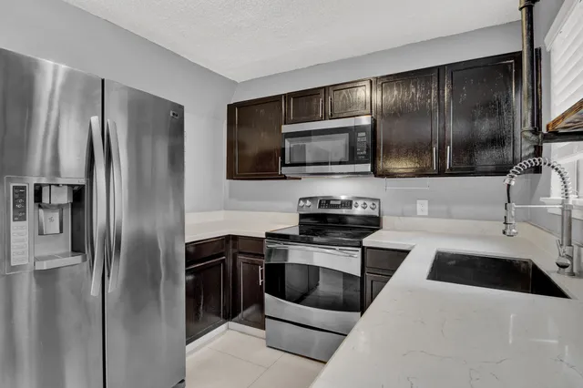 a kitchen with a refrigerator sink and microwave