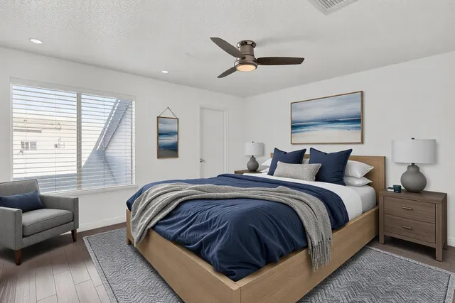 a spacious bedroom with a bed a couch and a window