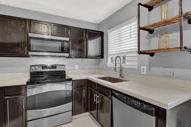 a kitchen with a sink stove and microwave