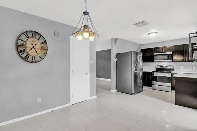 a kitchen with stainless steel appliances a refrigerator and a stove top oven