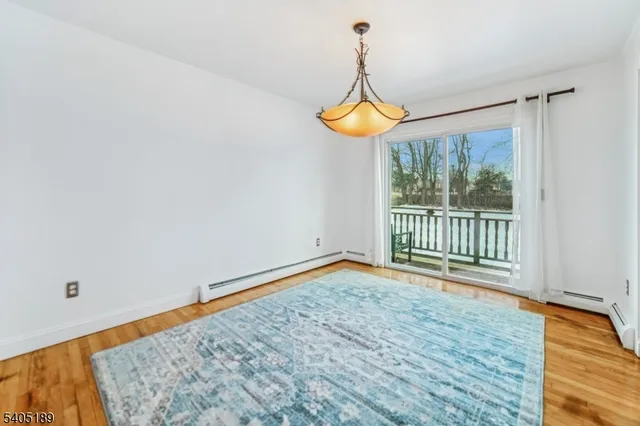 a view of a room with wooden floor and iron gate
