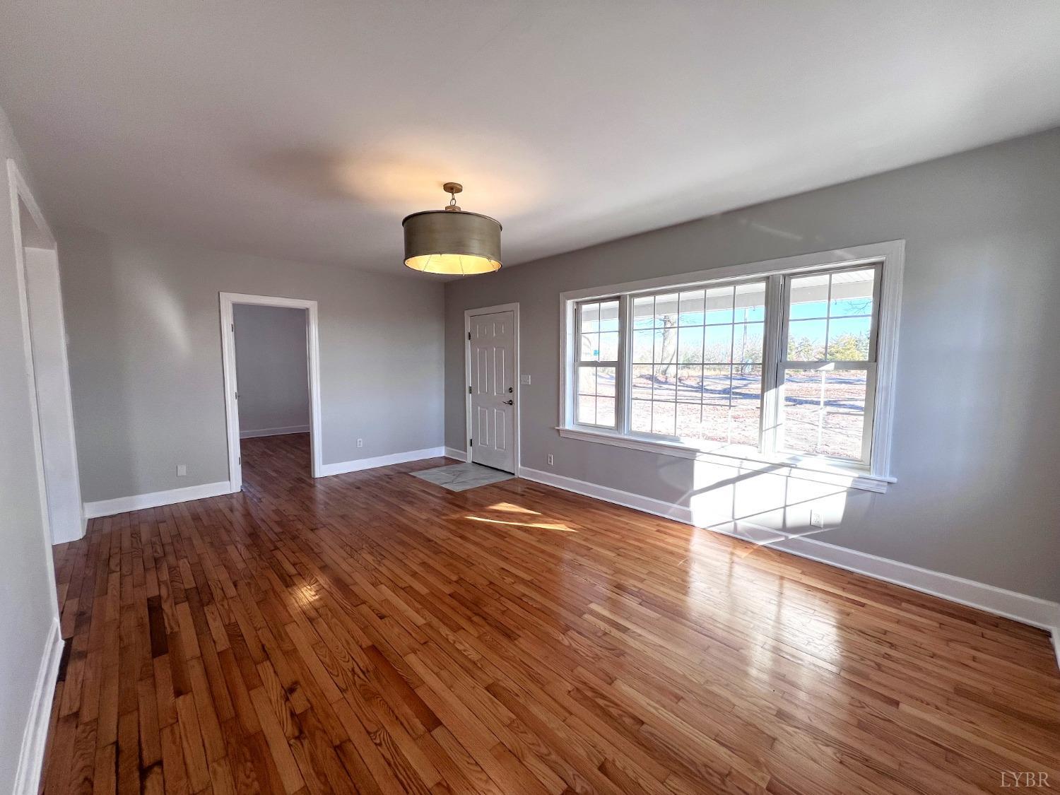 5235 Wards Fork Mill Road Cullen, VA 23934 - Photo 11 of 42 a view of an empty room with wooden floor and a window