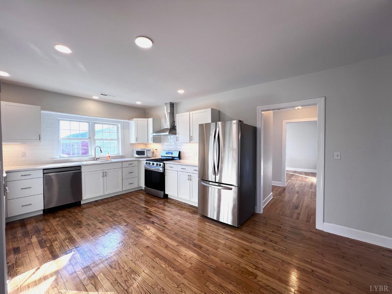 5235 Wards Fork Mill Road Cullen, VA 23934 - Photo 12 of 42 a kitchen with a refrigerator and a stove top oven