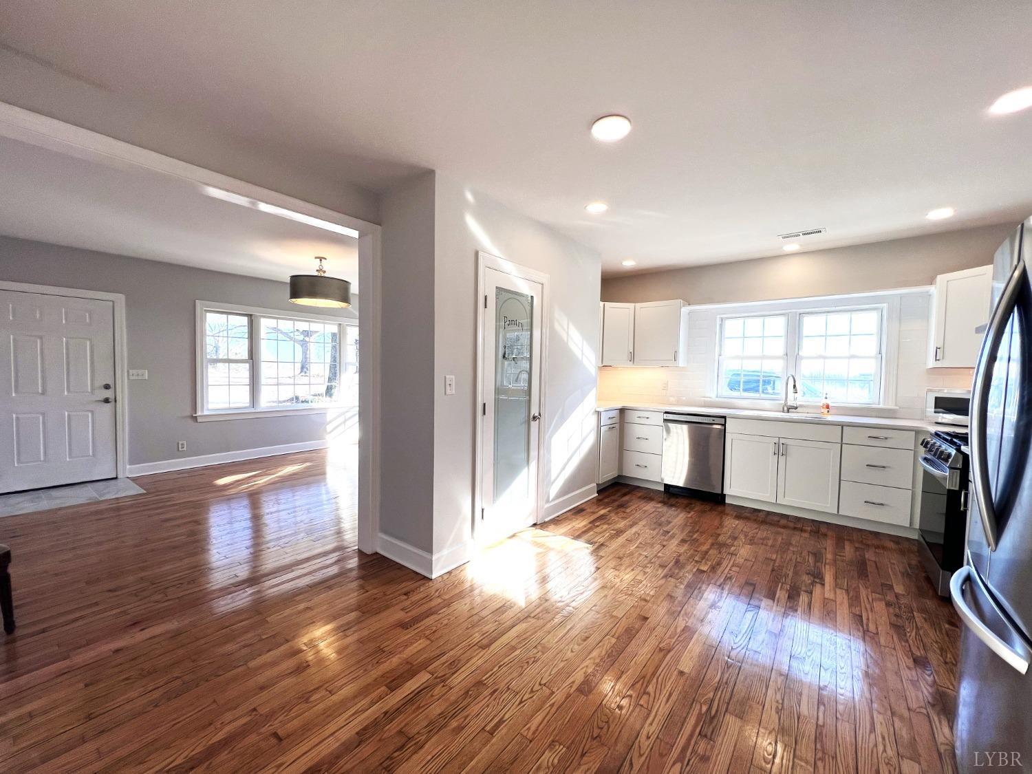 5235 Wards Fork Mill Road Cullen, VA 23934 - Photo 13 of 42 a view of a large kitchen with wooden floor and a window