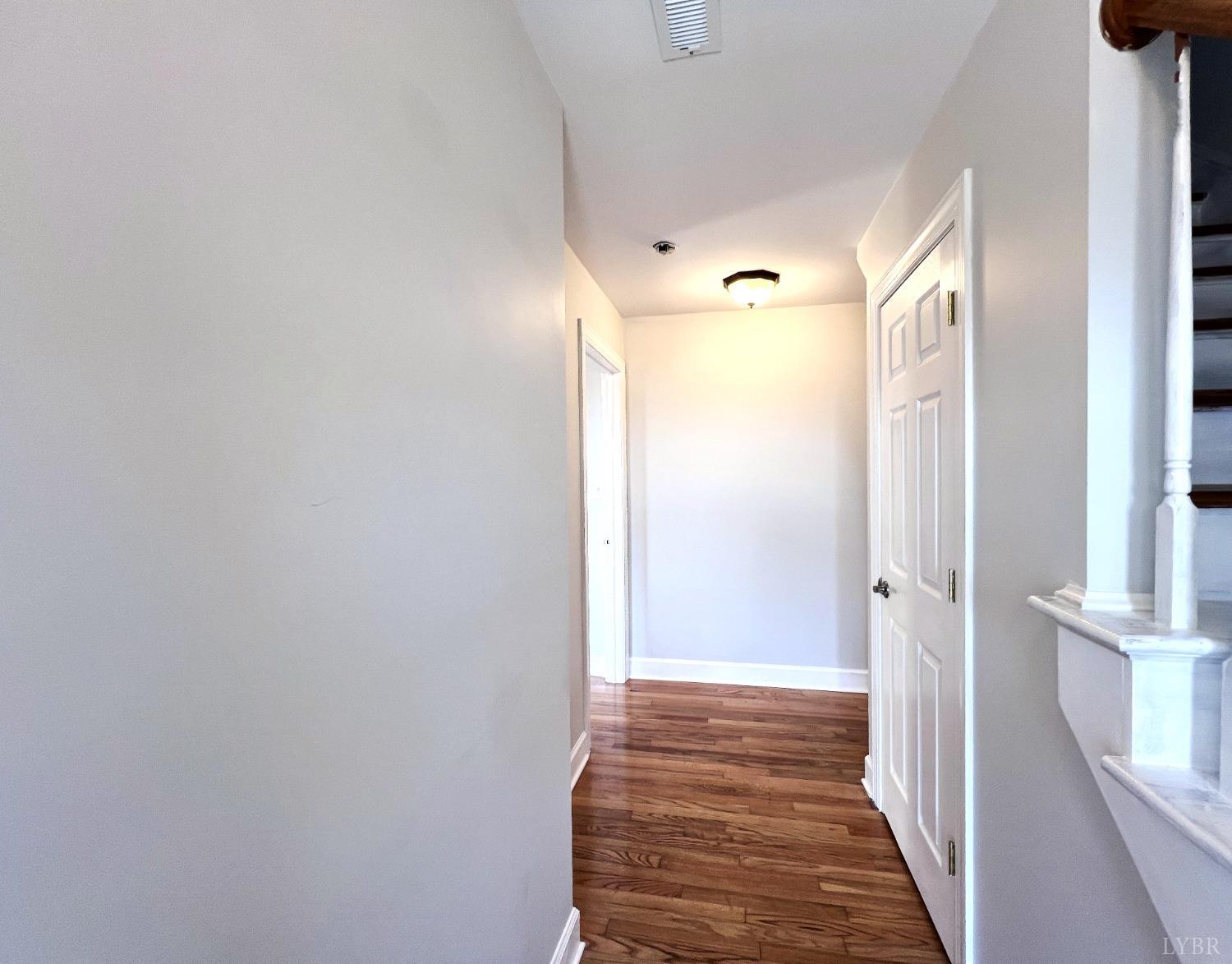 5235 Wards Fork Mill Road Cullen, VA 23934 - Photo 24 of 42 a view of a hallway with wooden floor and staircase