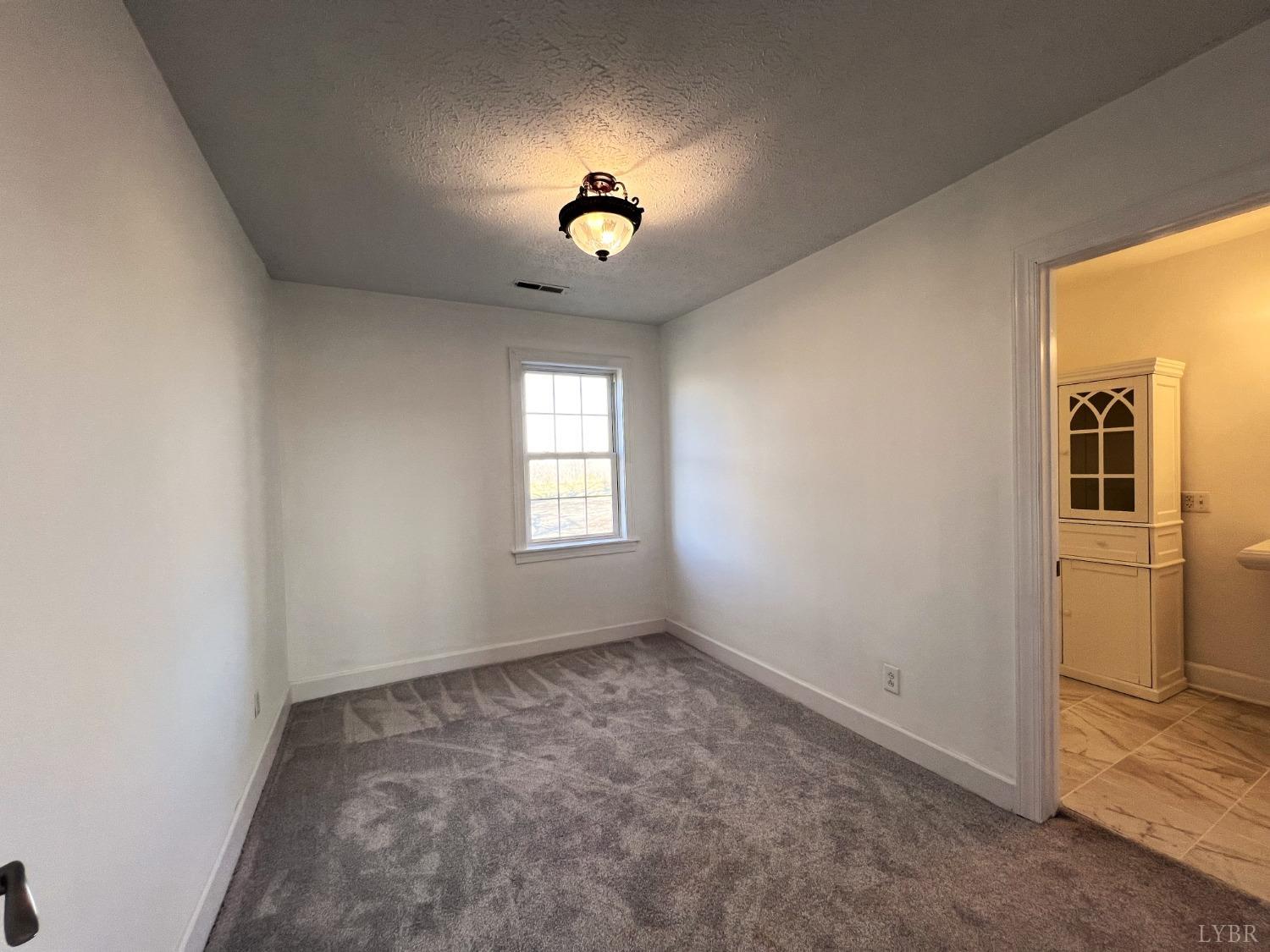 5235 Wards Fork Mill Road Cullen, VA 23934 - Photo 26 of 42 wooden floor in an empty room with a window