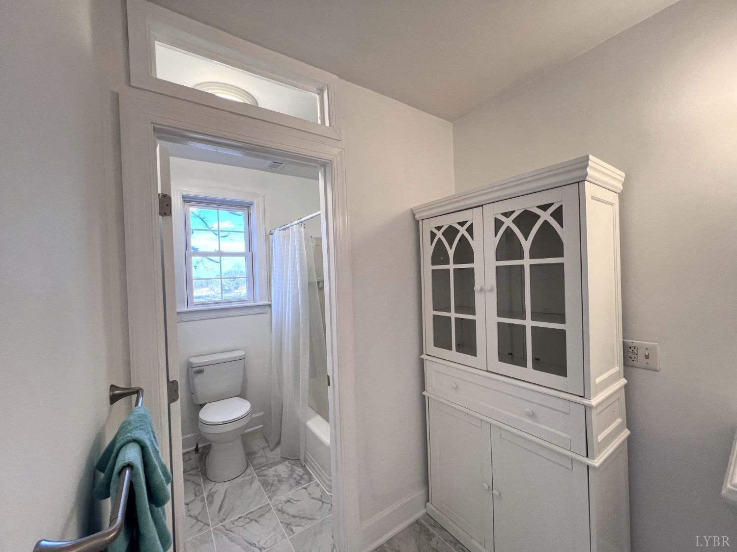 5235 Wards Fork Mill Road Cullen, VA 23934 - Photo 29 of 42 a bathroom with a toilet a sink and a window