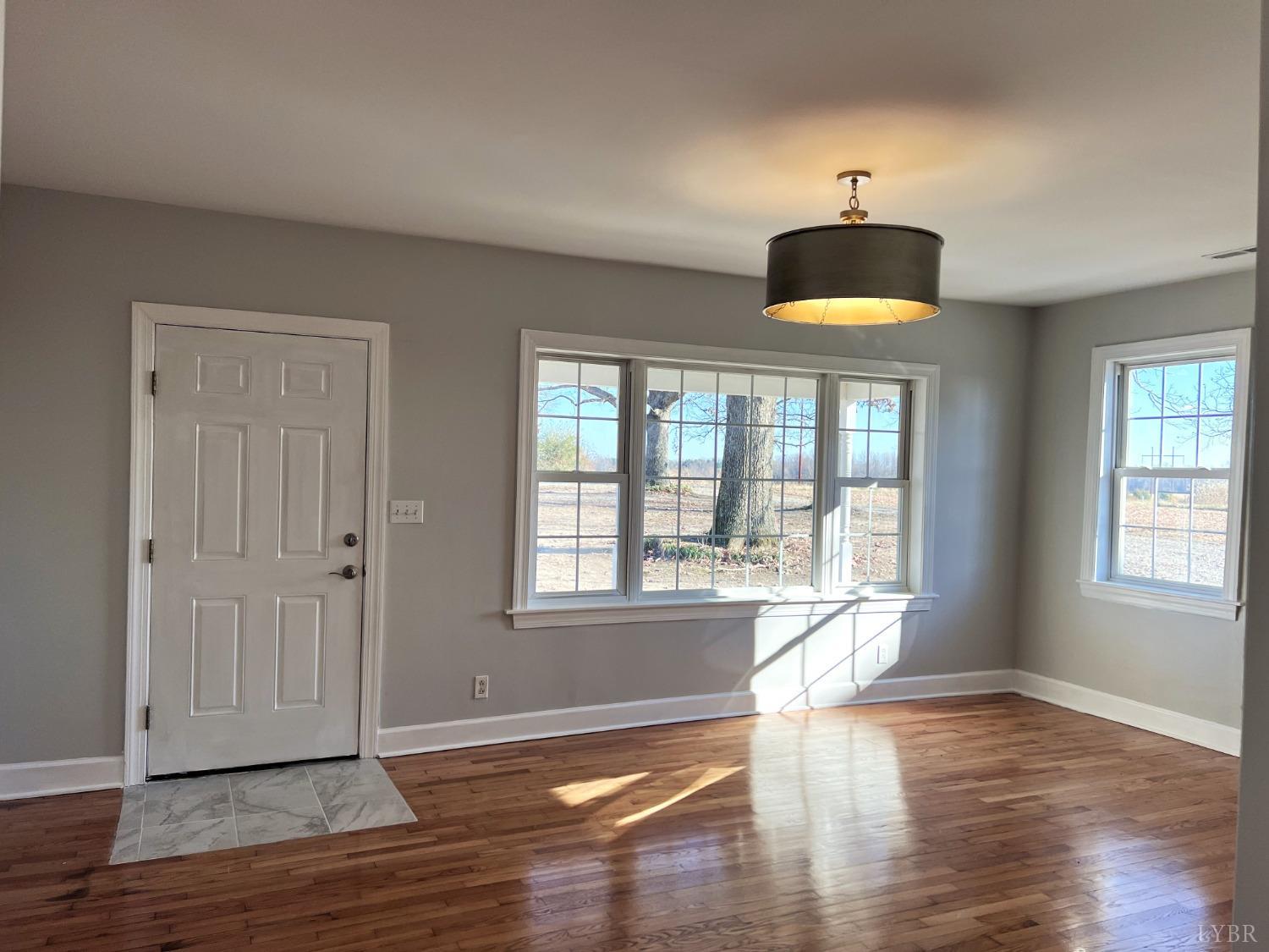 5235 Wards Fork Mill Road Cullen, VA 23934 - Photo 7 of 42 a view of an empty room with wooden floor and a window