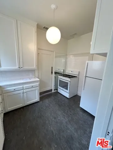 a kitchen with a refrigerator and a sink