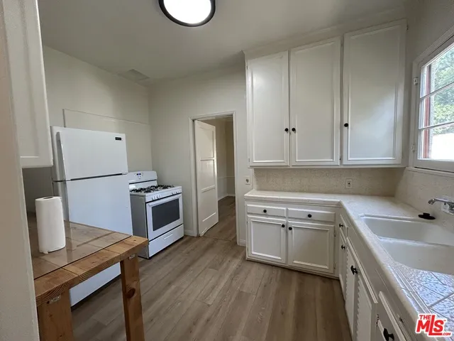 a living room with toilet a sink and a window