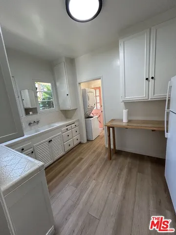a view of an empty room and wooden floor
