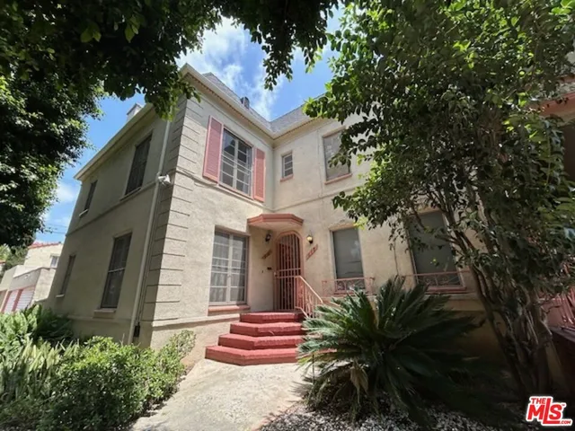 a front view of a house with a garden