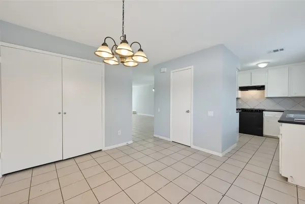 a kitchen with granite countertop a sink stove and cabinets