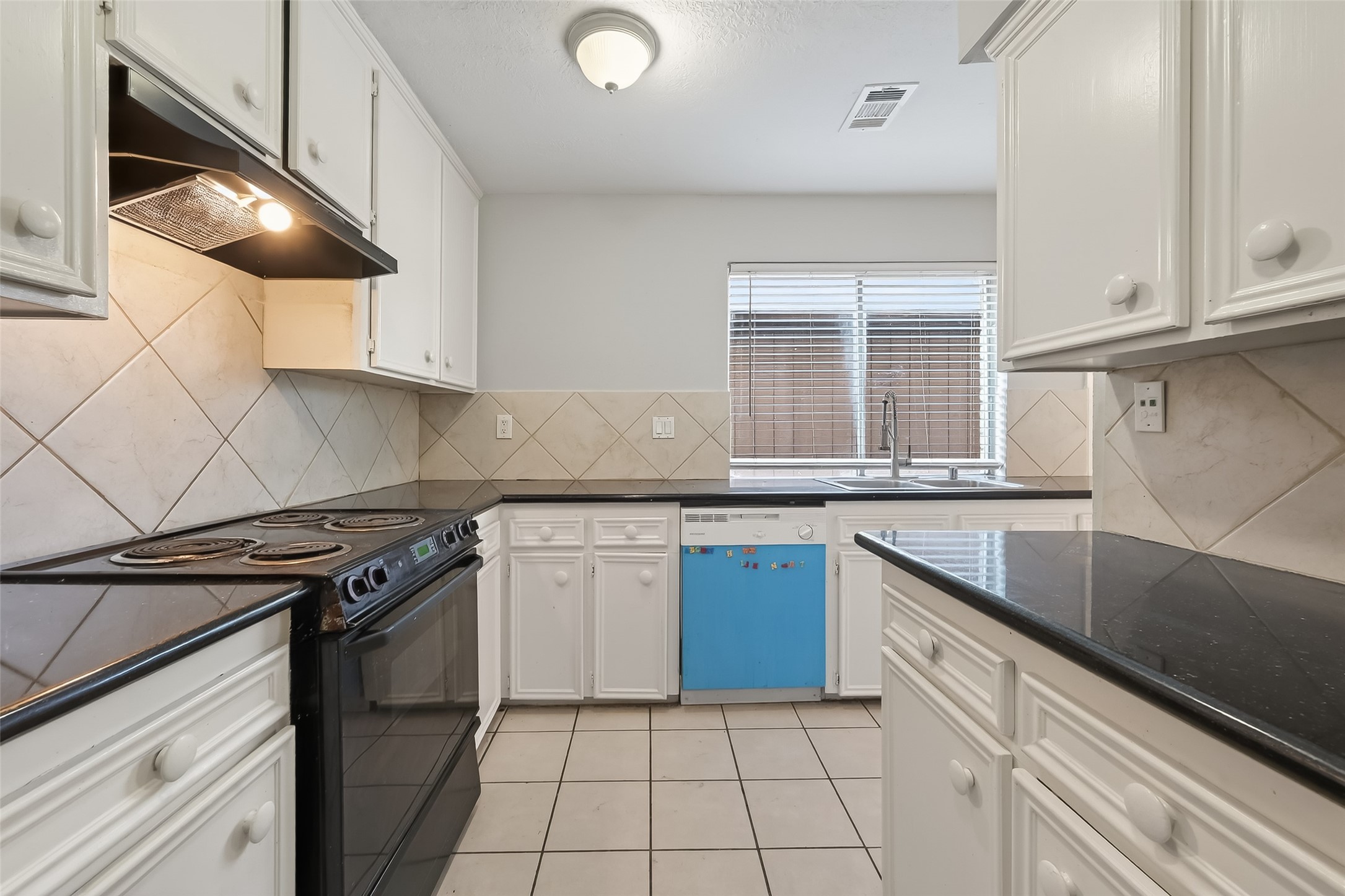 8646 Maplecrest Drive Houston, TX 77099 - Photo 19 of 36 a kitchen with granite countertop a sink a stove and cabinets