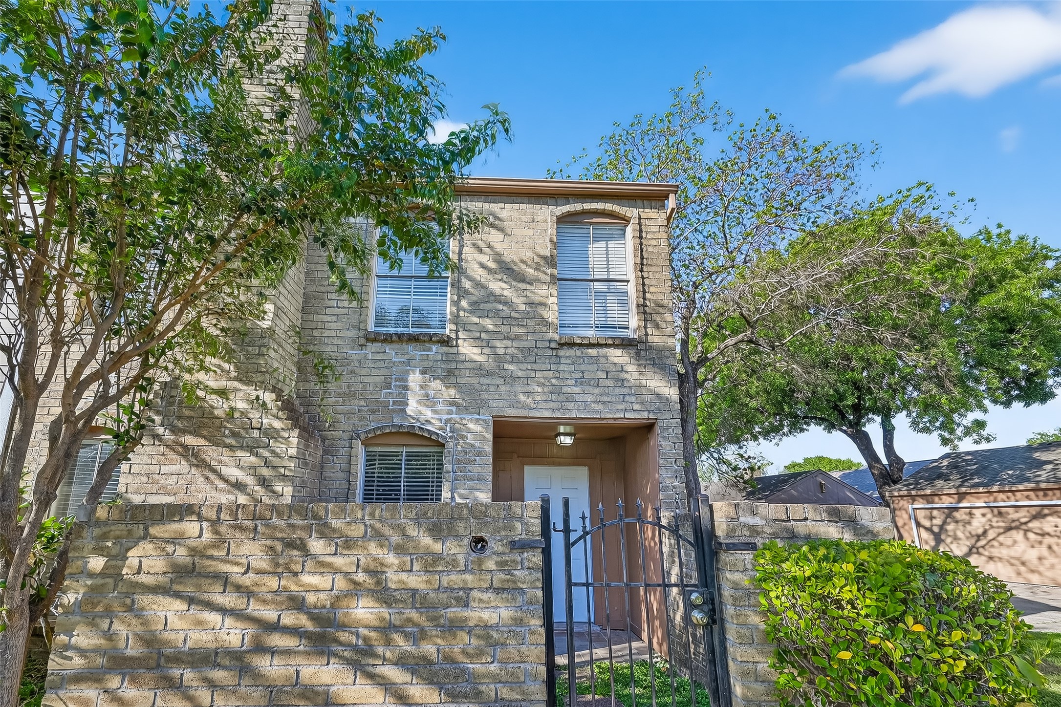 8646 Maplecrest Drive Houston, TX 77099 - Photo 2 of 36 a front view of a house with a garden