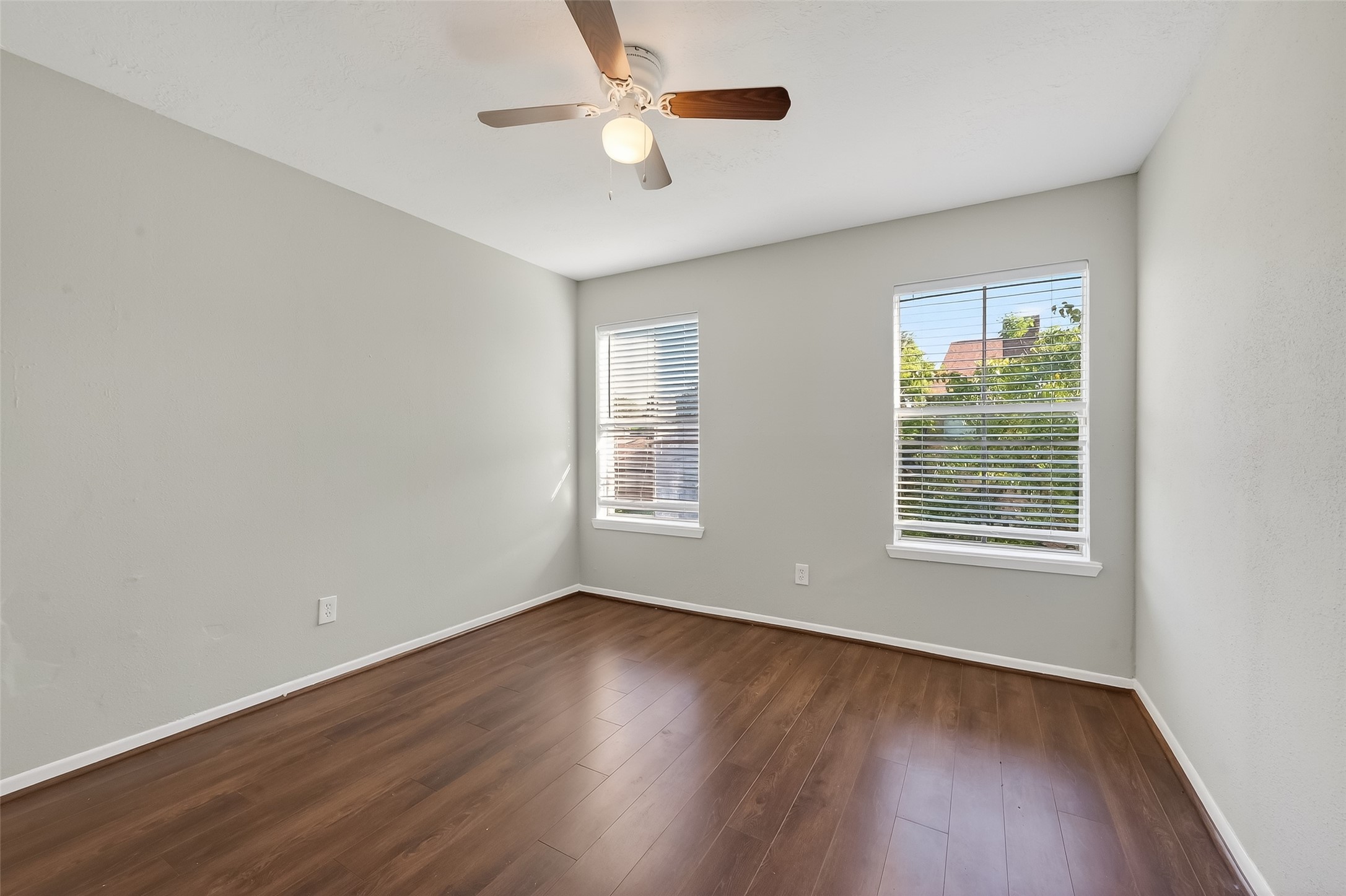 8646 Maplecrest Drive Houston, TX 77099 - Photo 21 of 36 a view of an empty room with wooden floor and a window
