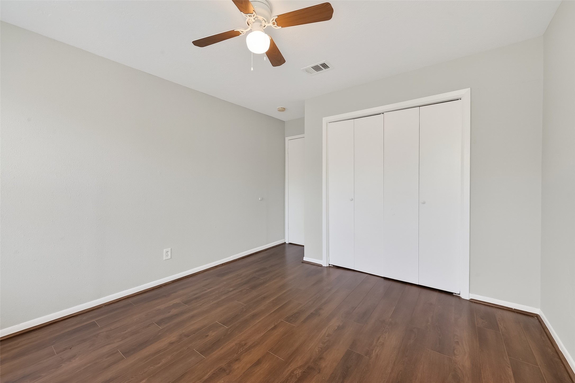 8646 Maplecrest Drive Houston, TX 77099 - Photo 22 of 36 a view of an empty room with wooden floor