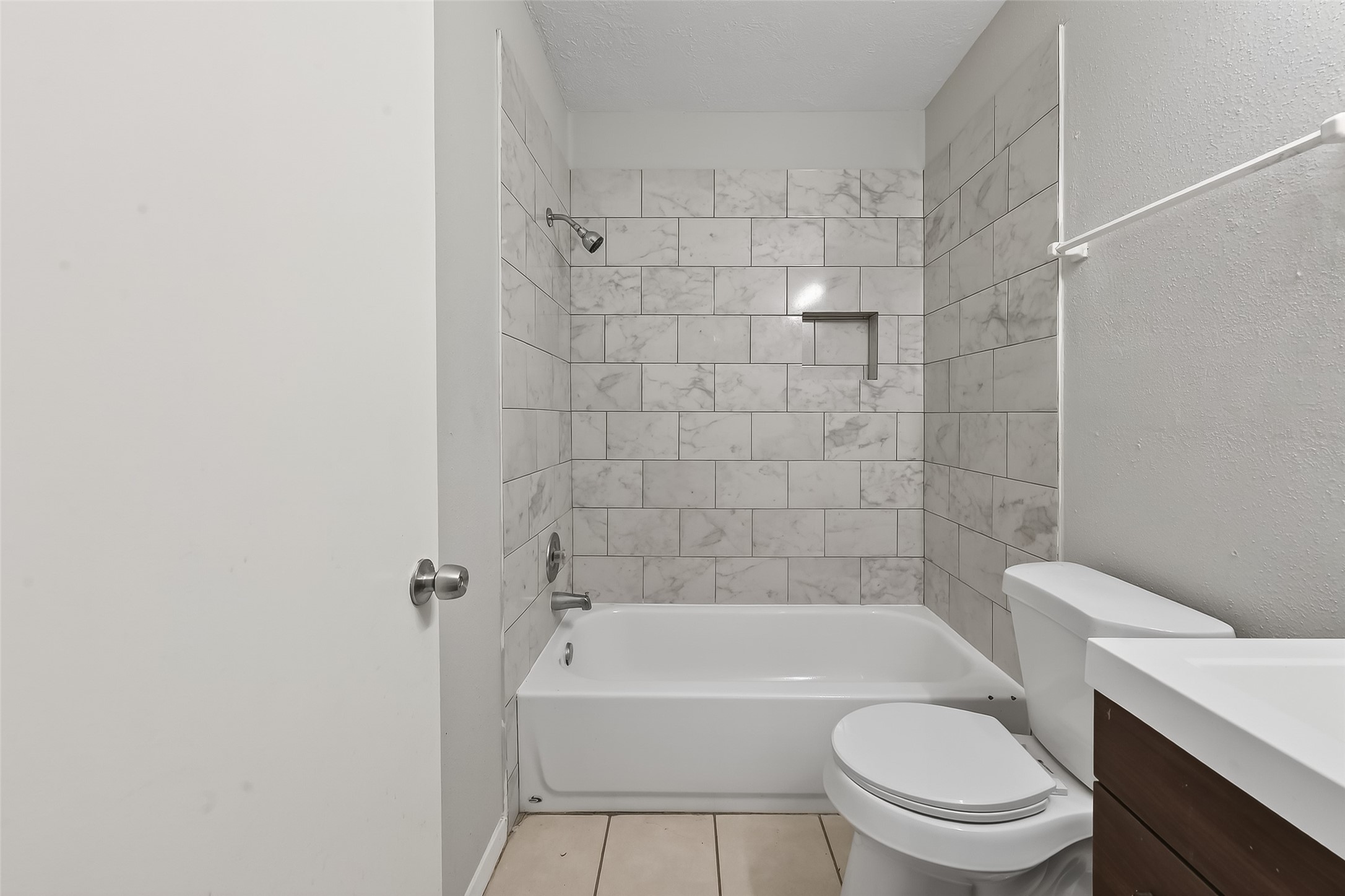 8646 Maplecrest Drive Houston, TX 77099 - Photo 23 of 36 a white toilet and tub sitting next to a bathroom sink
