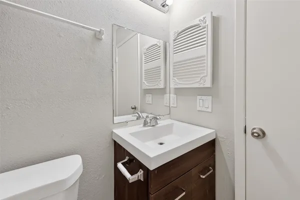 an empty room with wooden floor ceiling fan and window