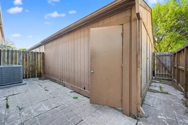 a view of house with backyard and wooden fence