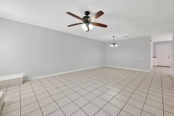 a view of a livingroom with a chandelier and fireplace