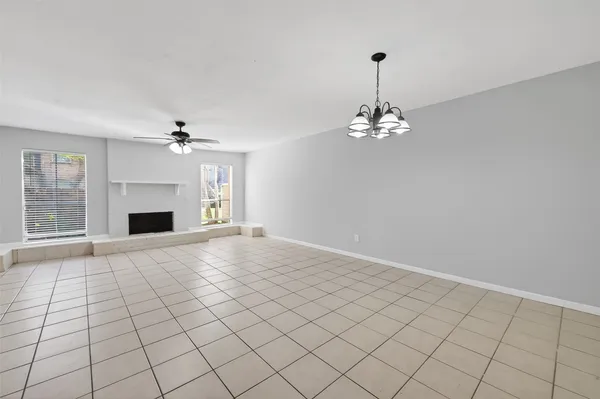 a view of an empty room with a kitchen