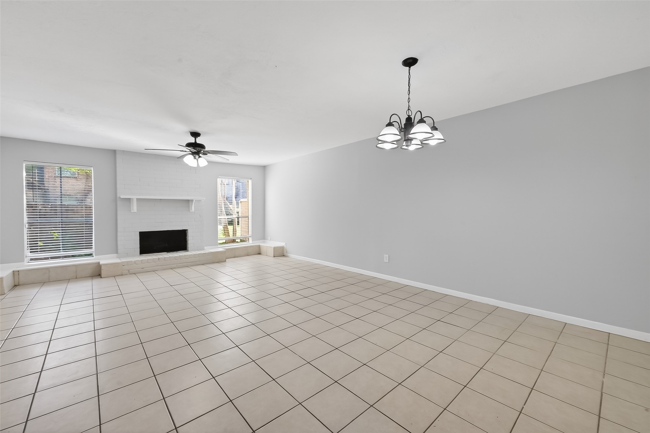 8646 Maplecrest Drive Houston, TX 77099 - Photo 8 of 36 a view of a livingroom with a chandelier and fireplace