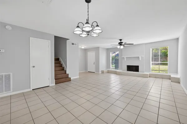 a living room with a large window and a fireplace