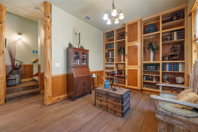 a room with lots of furniture and a chandelier