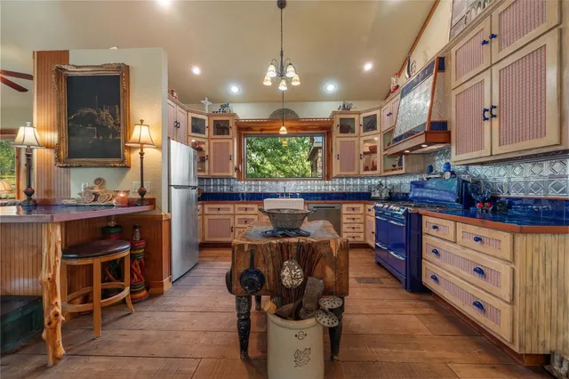 a kitchen with stainless steel appliances granite countertop a stove and a refrigerator