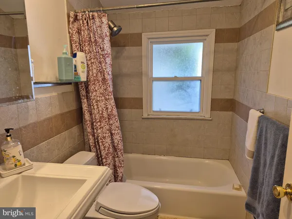 a bathroom with a sink a toilet and a bathtub