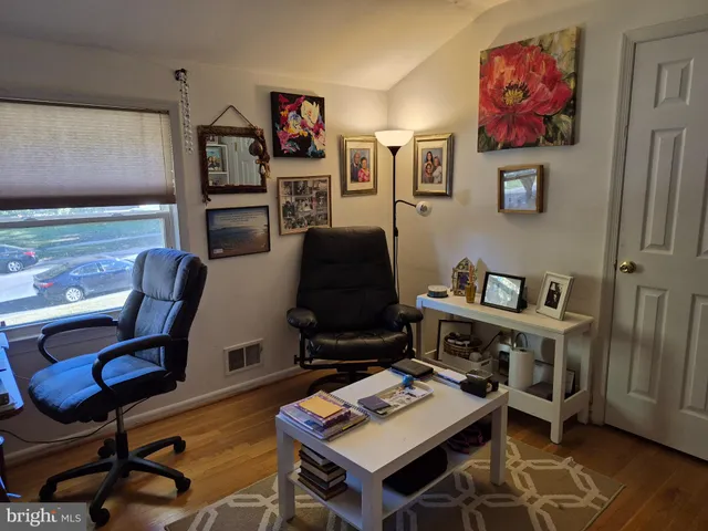 a workspace with furniture and wooden floor