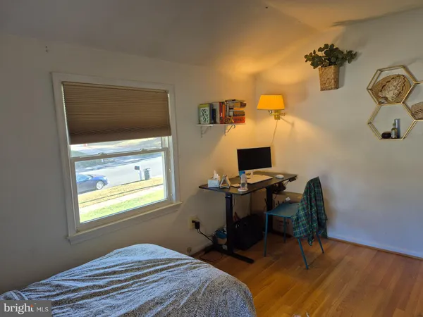 a bedroom with a workspace