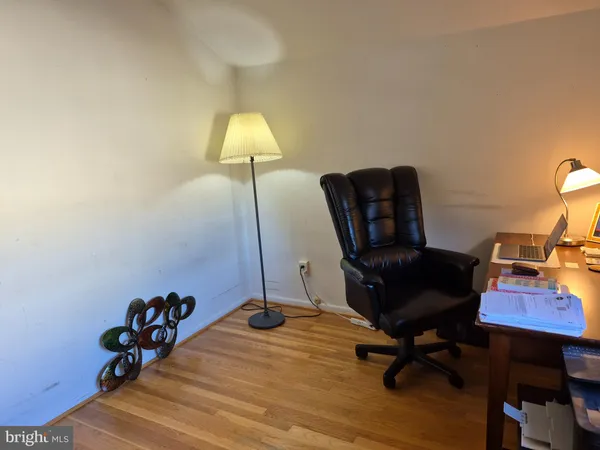 a view of a workspace with furniture and a chair