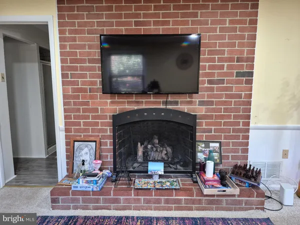 a living room with a fireplace and a fireplace