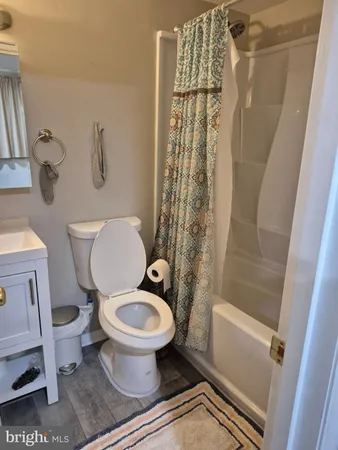 a white toilet sitting next to a bath tub shower