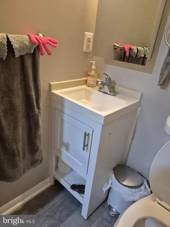 a bathroom with a sink mirror vanity and toilet