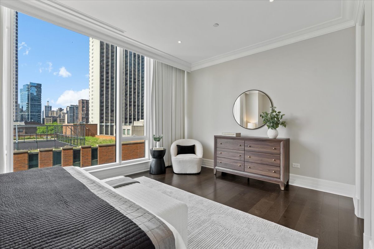 9 West Walton Street, Unit 702 Chicago, IL 60610 - Photo 20 of 38 a bedroom with furniture and a large window