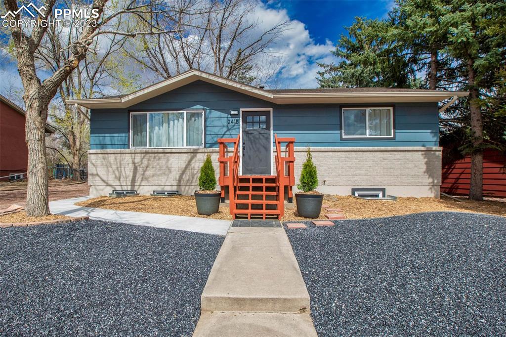 2415 Monterey Road Colorado Springs, CO 80910 - Photo 1 of 36 a front view of a house with a yard and garage