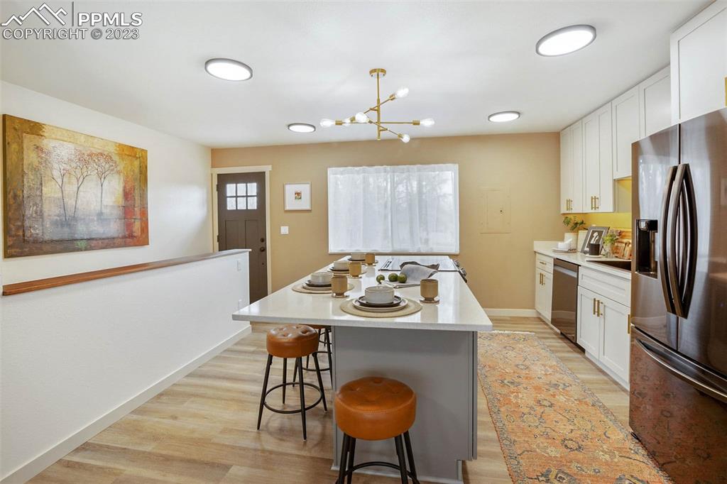 2415 Monterey Road Colorado Springs, CO 80910 - Photo 12 of 36 a kitchen with furniture a refrigerator and a stove