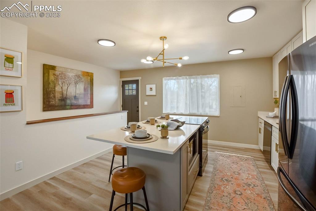 2415 Monterey Road Colorado Springs, CO 80910 - Photo 13 of 36 a kitchen with a refrigerator and a stove