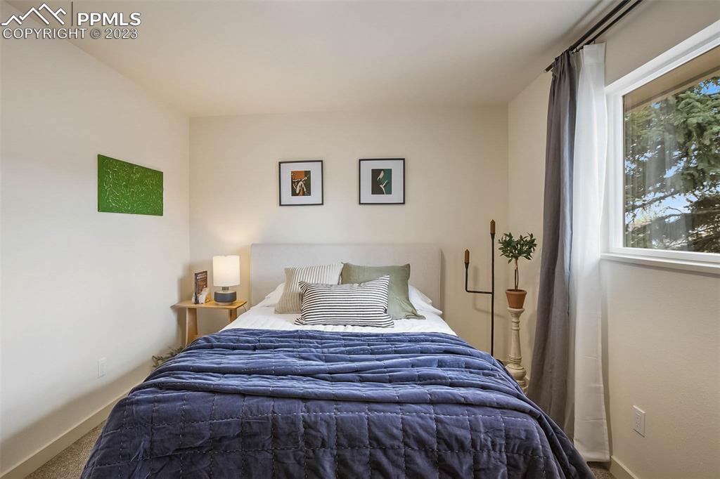 2415 Monterey Road Colorado Springs, CO 80910 - Photo 16 of 36 a bedroom with a bed and a window