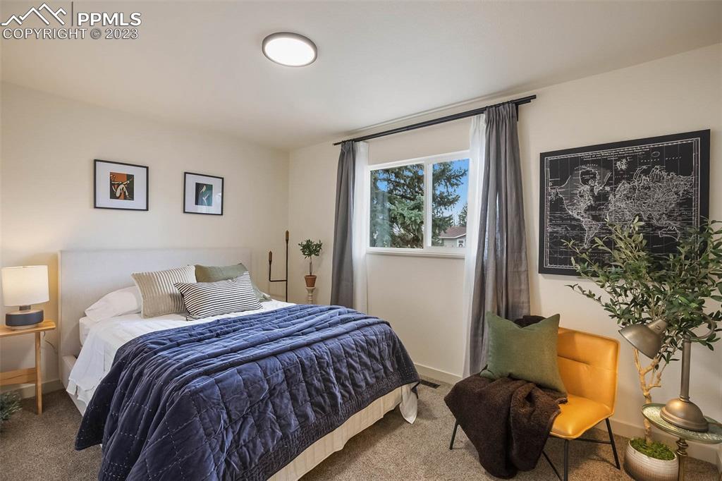 2415 Monterey Road Colorado Springs, CO 80910 - Photo 18 of 36 a bedroom with a bed and a window