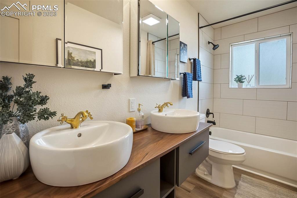 2415 Monterey Road Colorado Springs, CO 80910 - Photo 19 of 36 a bathroom with a sink a toilet and shower