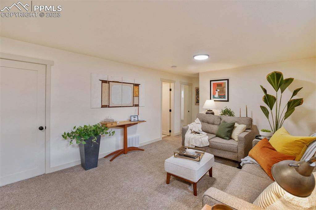 2415 Monterey Road Colorado Springs, CO 80910 - Photo 20 of 36 a living room with furniture flowerpot and a window