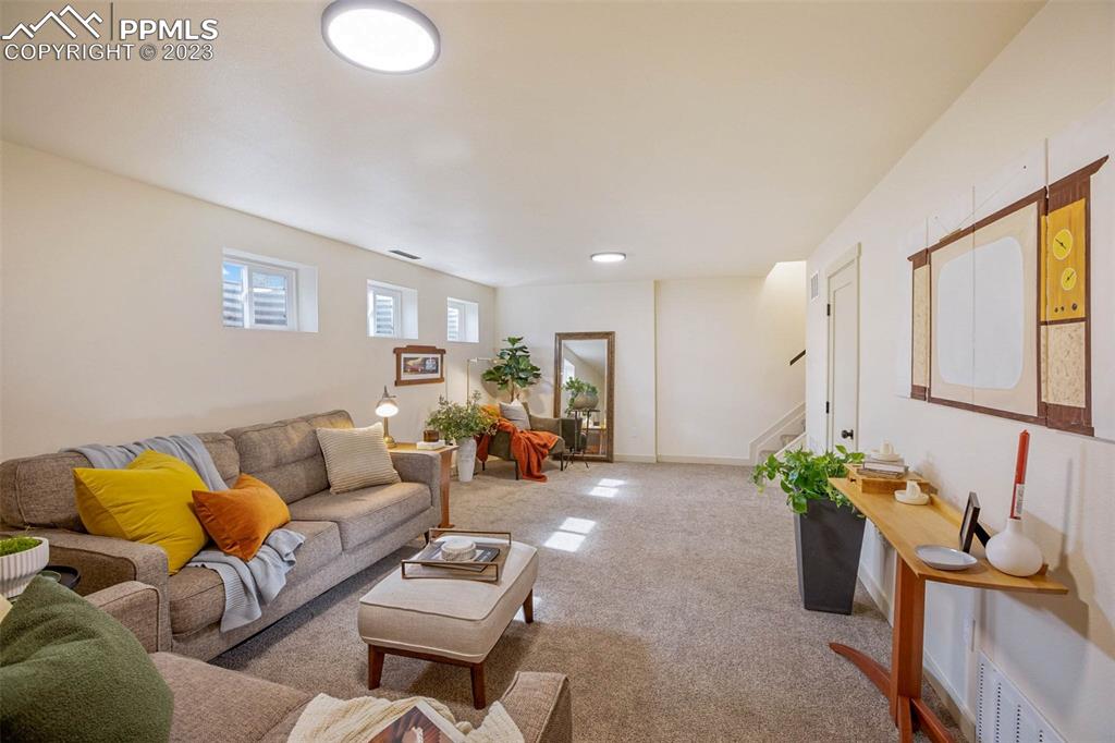 2415 Monterey Road Colorado Springs, CO 80910 - Photo 24 of 36 a living room with furniture flowerpot and a chandelier